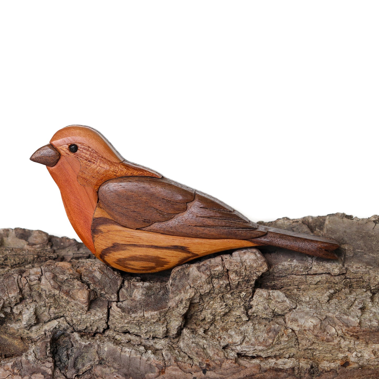 Wood carved ornament of a house finch songbird using the woods black walnut, red cedar, zebrawood, and mahogany.