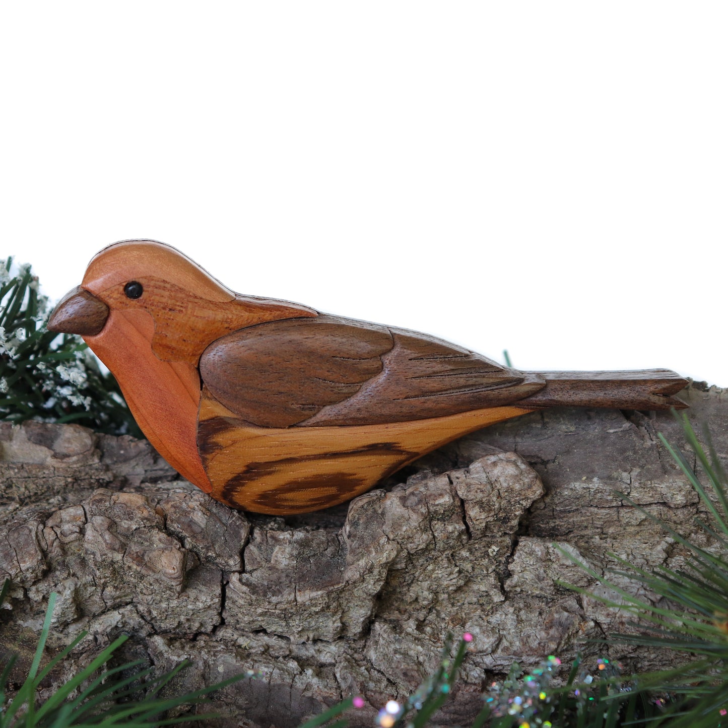 House finch songbird made out of wood using a scroll saw using the intarsia style woodworking to create a wood ornament or a magnet for a christmas tree.