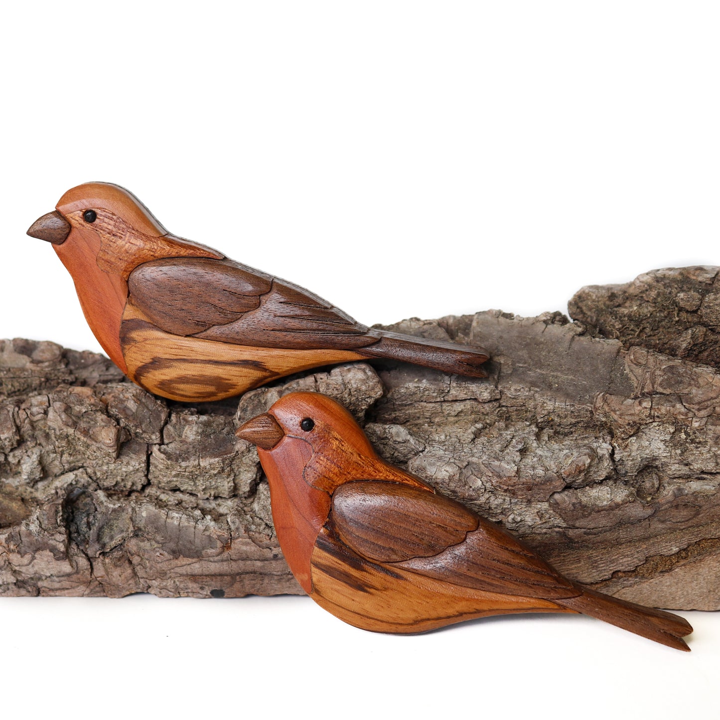 Two house finch songbirds made out of wood perched on a bark facing left made using a scroll saw and sanded smooth