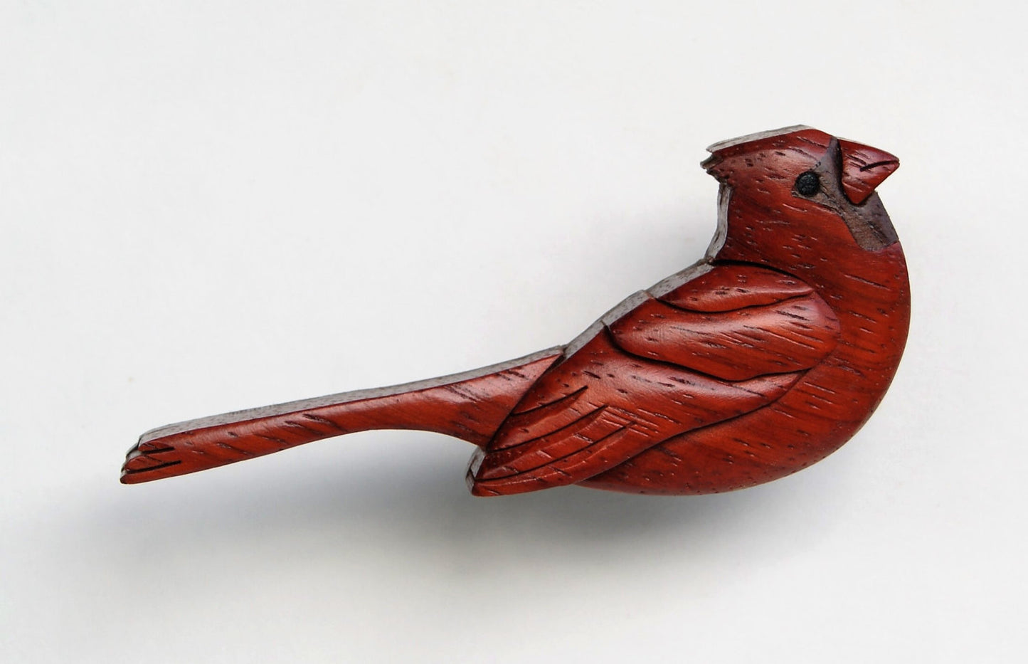 wood carved intarsia miniature of a cardinal made from padauk and peruvian walnut